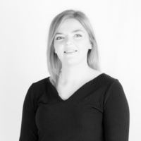 grey filtered headshot of Carlie Martin